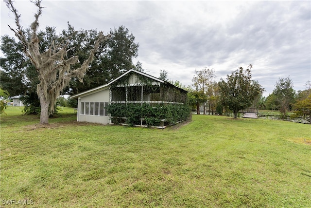 view of yard featuring a sunroom