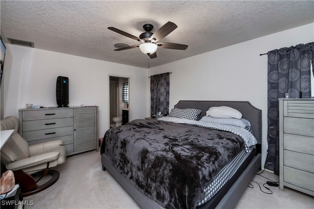 carpeted bedroom with a textured ceiling and ceiling fan