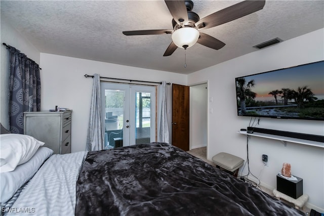 bedroom with a textured ceiling, french doors, ceiling fan, and access to exterior