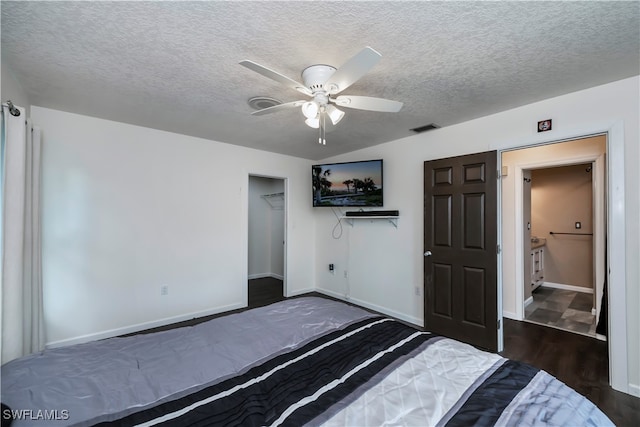 unfurnished bedroom featuring dark hardwood / wood-style flooring, a closet, a textured ceiling, and ceiling fan