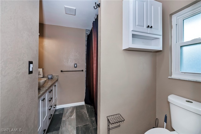 bathroom with vanity and toilet