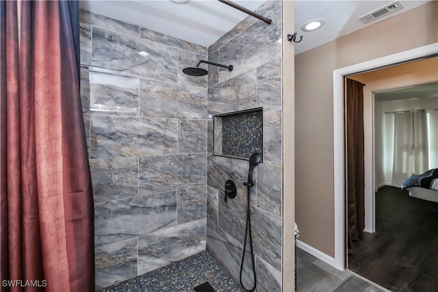 bathroom with a shower with shower curtain and hardwood / wood-style flooring