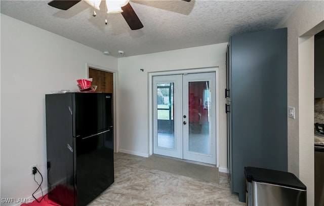 kitchen with a textured ceiling, french doors, ceiling fan, and black refrigerator