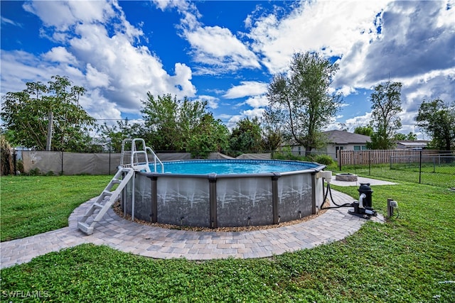 view of swimming pool with a lawn