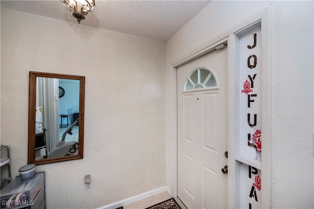 foyer entrance featuring a textured ceiling