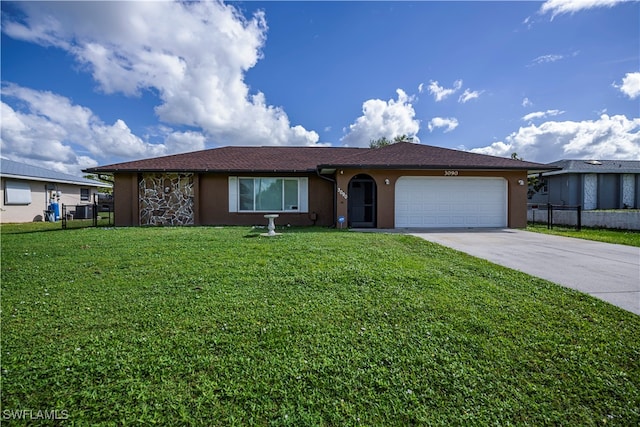 single story home with a garage and a front lawn