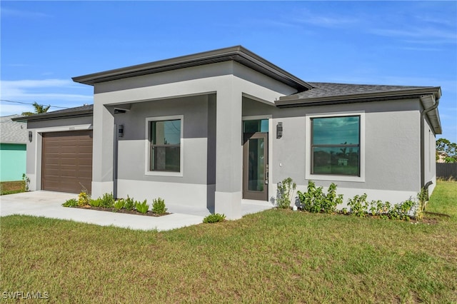 view of front of home featuring a garage and a front yard