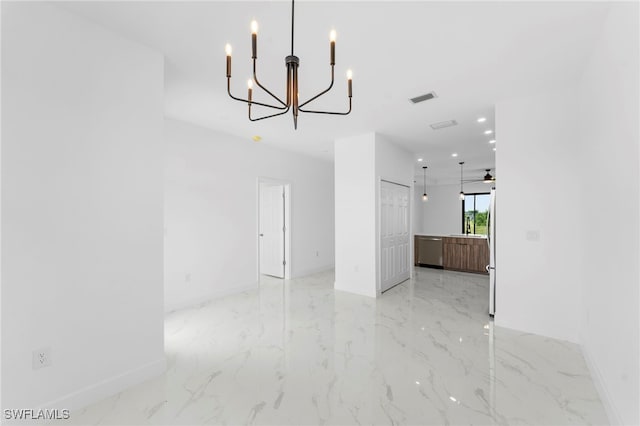 unfurnished dining area featuring ceiling fan with notable chandelier