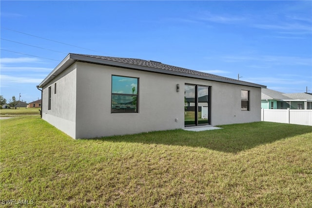 rear view of house with a lawn