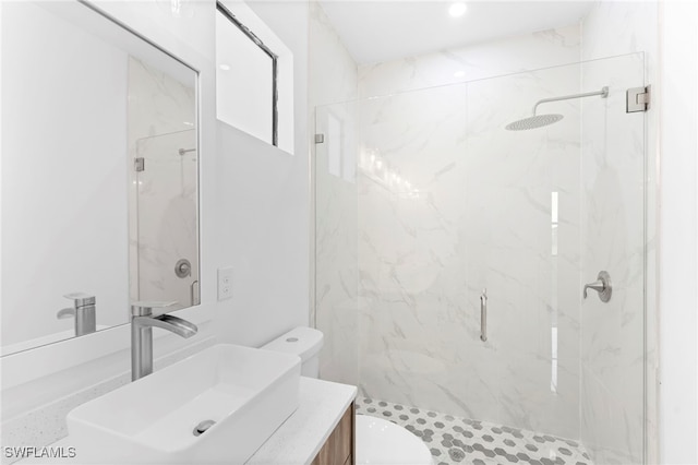 bathroom with vanity, a shower with shower door, and toilet