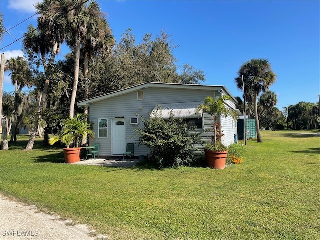 view of side of home featuring a lawn