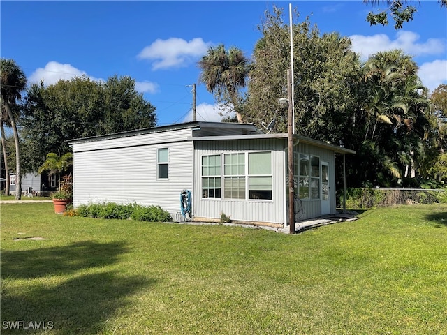 rear view of property featuring a yard