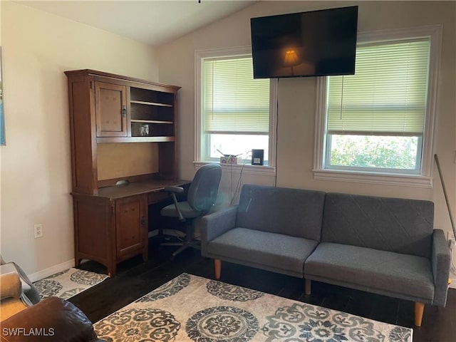 1048 Arvin Ln, Moore Haven, FL 33471 - living area with wood finished floors, baseboards, lofted ceiling, plenty of natural light, and a desk