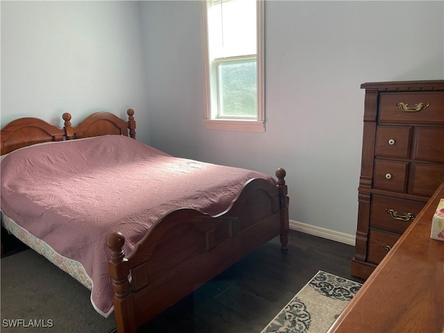 1048 Arvin Ln, Moore Haven, FL 33471 - bedroom with baseboards and dark wood-style flooring