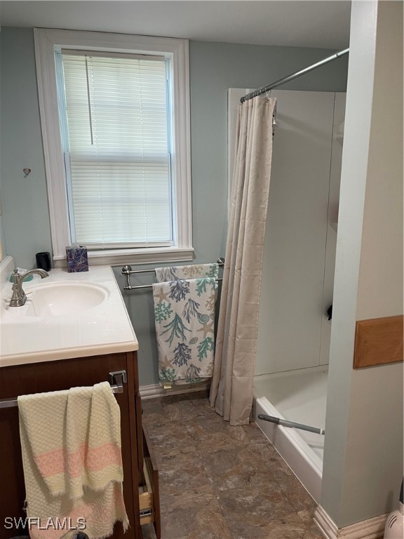 bathroom featuring a shower with shower curtain, a wealth of natural light, and vanity