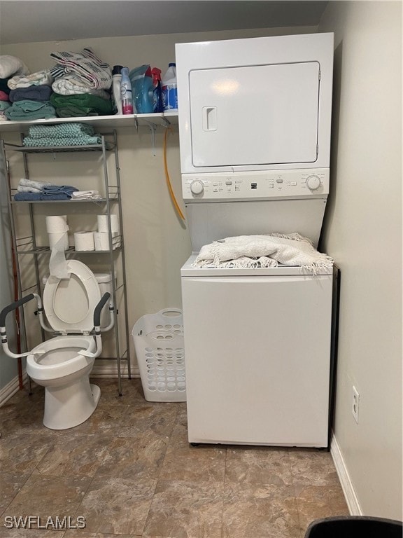 laundry area featuring stacked washer and clothes dryer