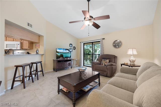 tiled living room with lofted ceiling and ceiling fan