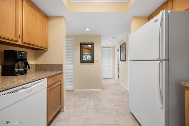 kitchen with light tile patterned floors and white appliances