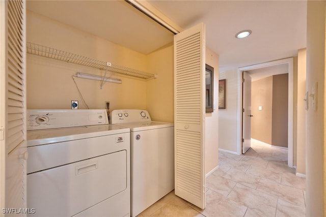 laundry area featuring independent washer and dryer and light tile patterned floors