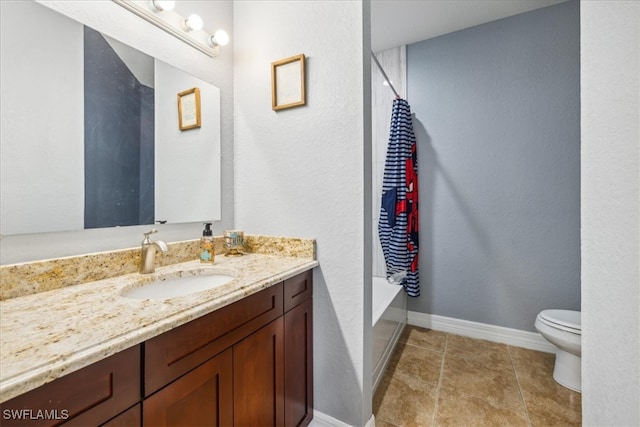 bathroom with vanity, a tub to relax in, tile patterned floors, and toilet