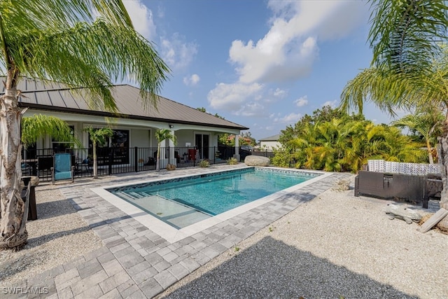 view of swimming pool featuring a patio area