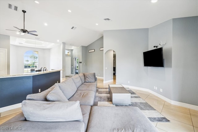 living room featuring ceiling fan, light tile patterned floors, and high vaulted ceiling