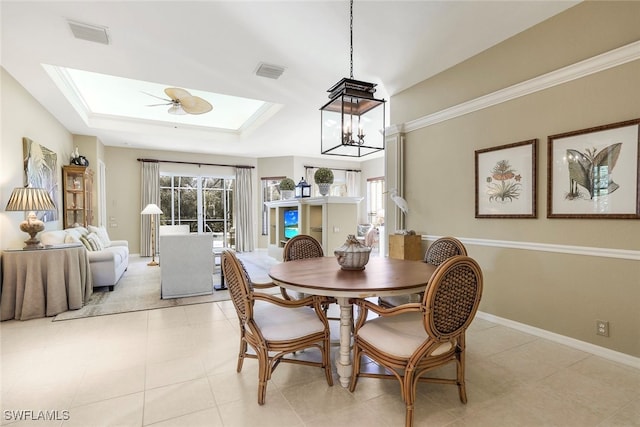 dining room with a skylight, light tile patterned floors, and ceiling fan