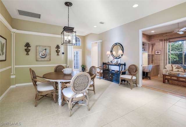 tiled dining space with ceiling fan with notable chandelier