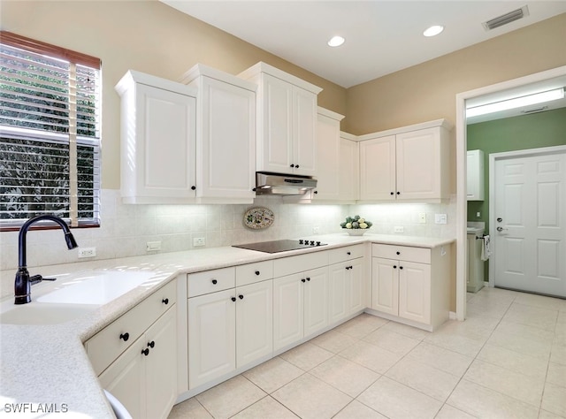 kitchen featuring white cabinets, sink, black electric cooktop, and light tile patterned floors