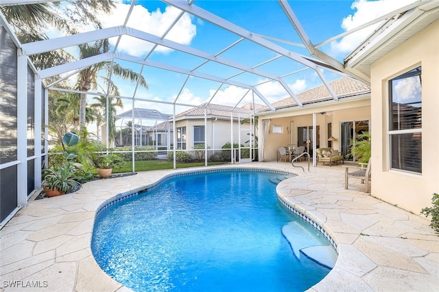 view of pool featuring ceiling fan, a lanai, and a patio