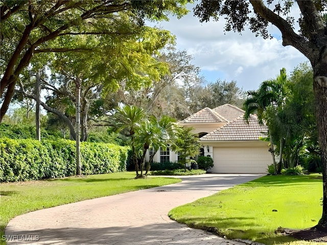 view of front of house with a garage and a front yard