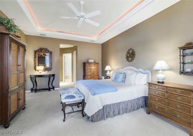 bedroom with ceiling fan, a raised ceiling, and light colored carpet