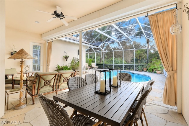 view of patio featuring ceiling fan and a lanai