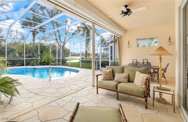 view of swimming pool featuring a lanai, ceiling fan, and a patio area