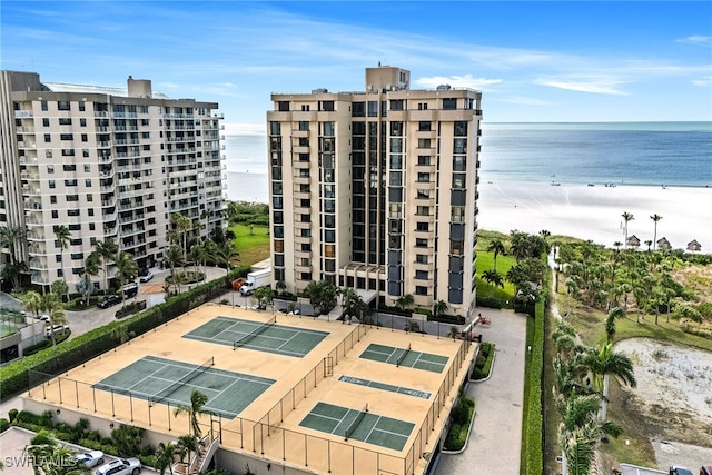 view of property featuring a water view and a beach view