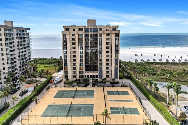 view of property with a water view and a beach view