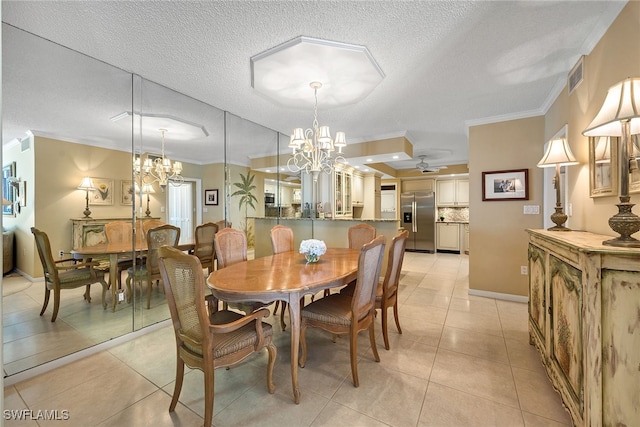 tiled dining area featuring a textured ceiling, ornamental molding, and ceiling fan with notable chandelier