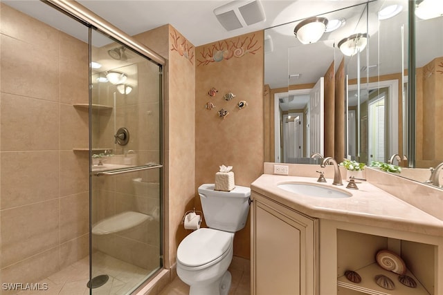 bathroom with toilet, vanity, an enclosed shower, and tile patterned floors