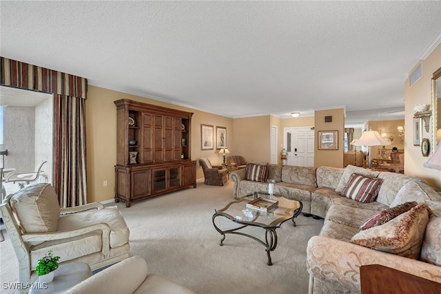 carpeted living room featuring a textured ceiling and crown molding