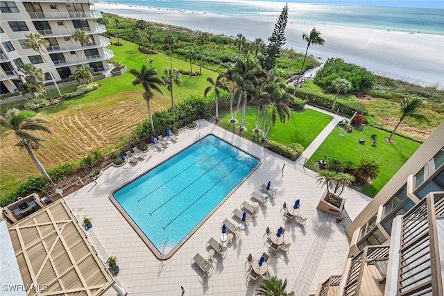 view of pool with a water view and a view of the beach