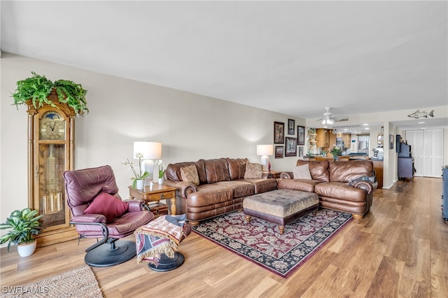 living room featuring ceiling fan and light wood-type flooring