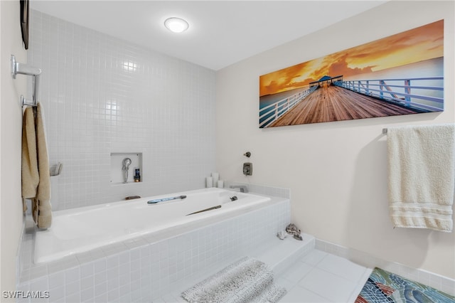 bathroom with tile patterned flooring and a relaxing tiled tub