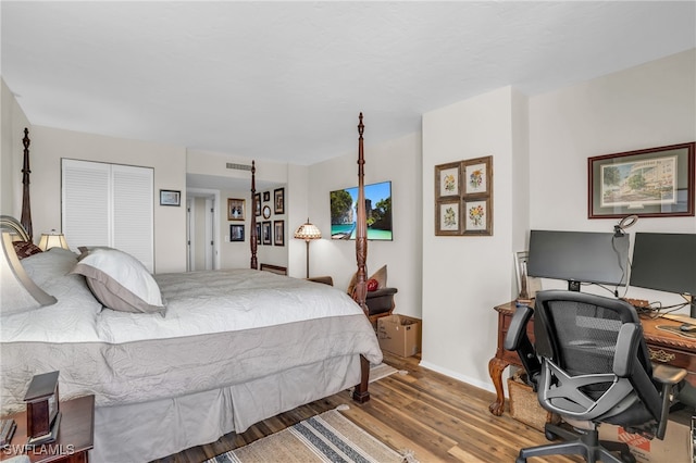 bedroom with a closet and hardwood / wood-style flooring