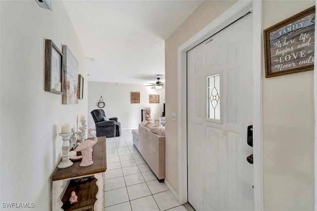 entryway featuring light tile patterned floors and ceiling fan