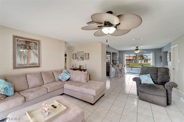 living room featuring light tile patterned floors and ceiling fan