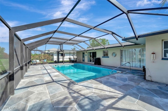 view of swimming pool featuring glass enclosure and a patio area