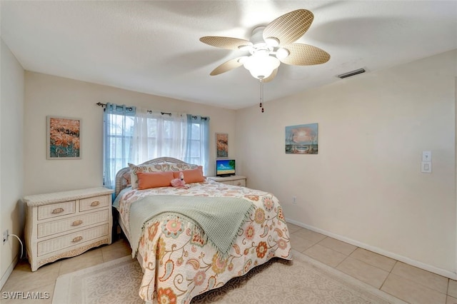 bedroom with ceiling fan and light tile patterned flooring