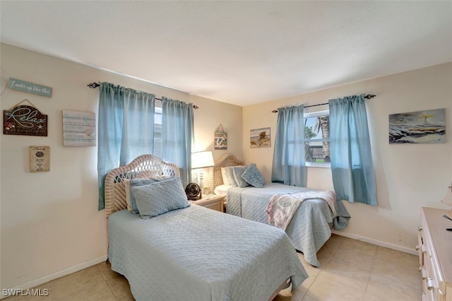 tiled bedroom with multiple windows