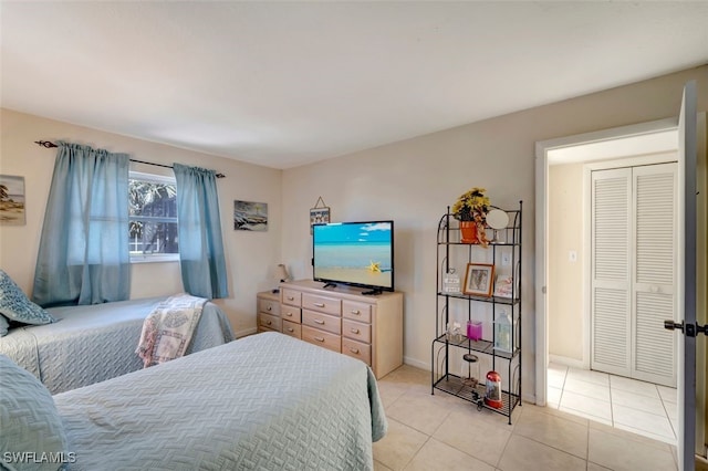 bedroom featuring a closet and light tile patterned floors