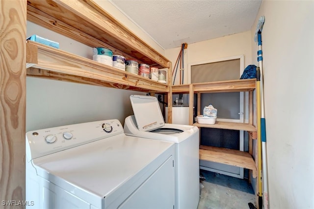 laundry area with independent washer and dryer, gas water heater, and a textured ceiling